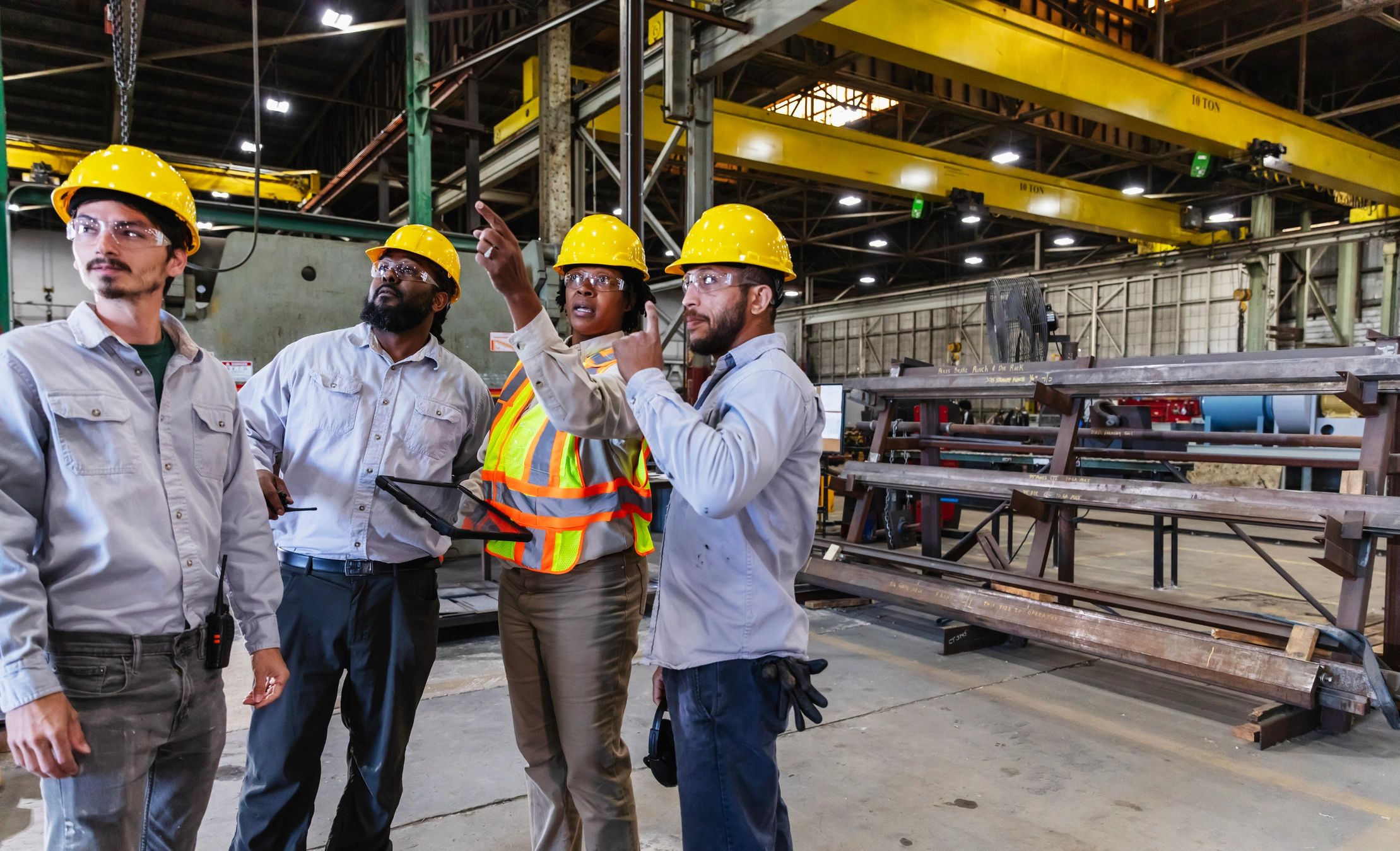 Steel fabrication team coordinating work on a factory floor
