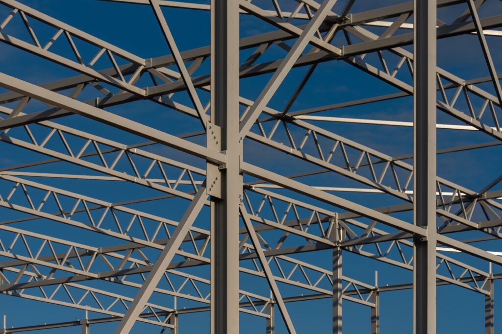 Structural steel framework and trusses against blue sky